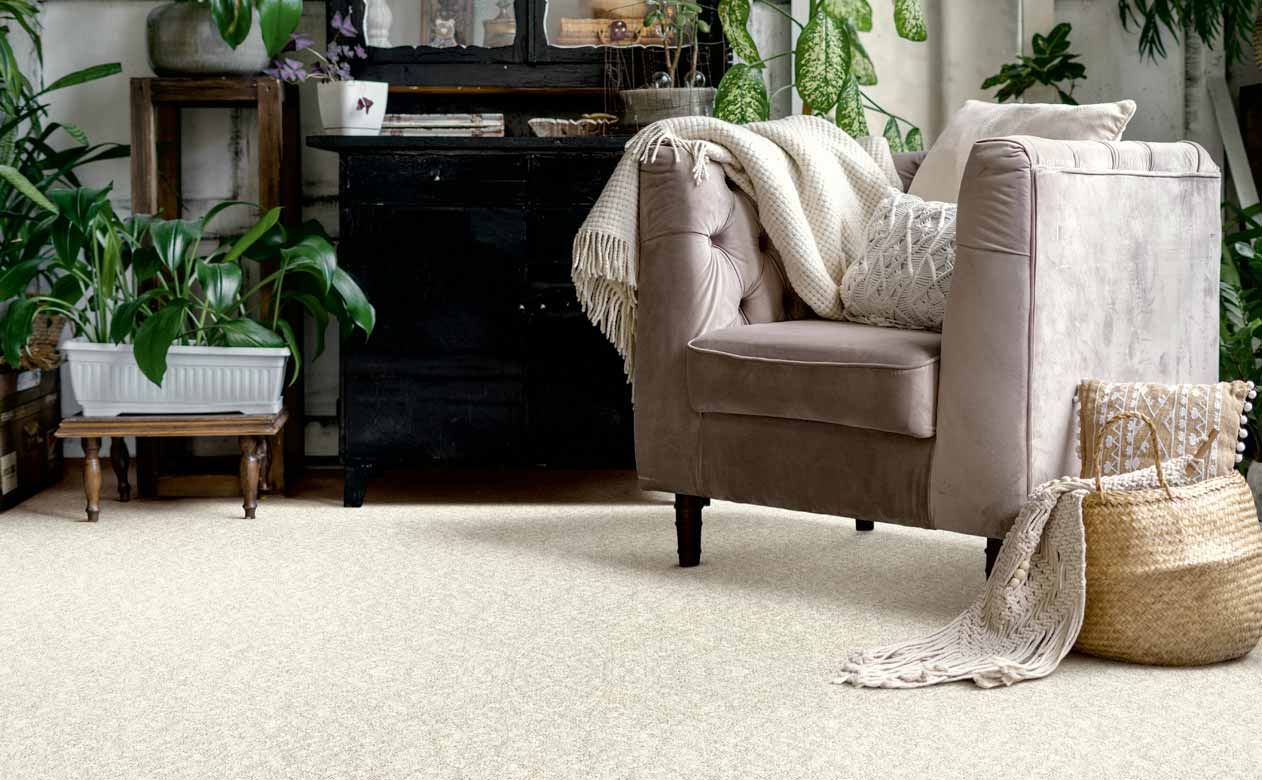 Living room with brown chair, dresser and beige carpet